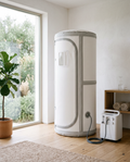 Vertical soft-shell home hyperbaric oxygen chamber with oxygen concentrator in a bright modern wellness room