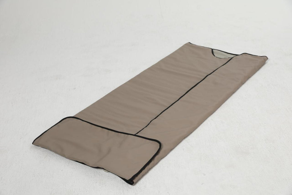 Infrared sauna blanket unzipped and laid open on the floor